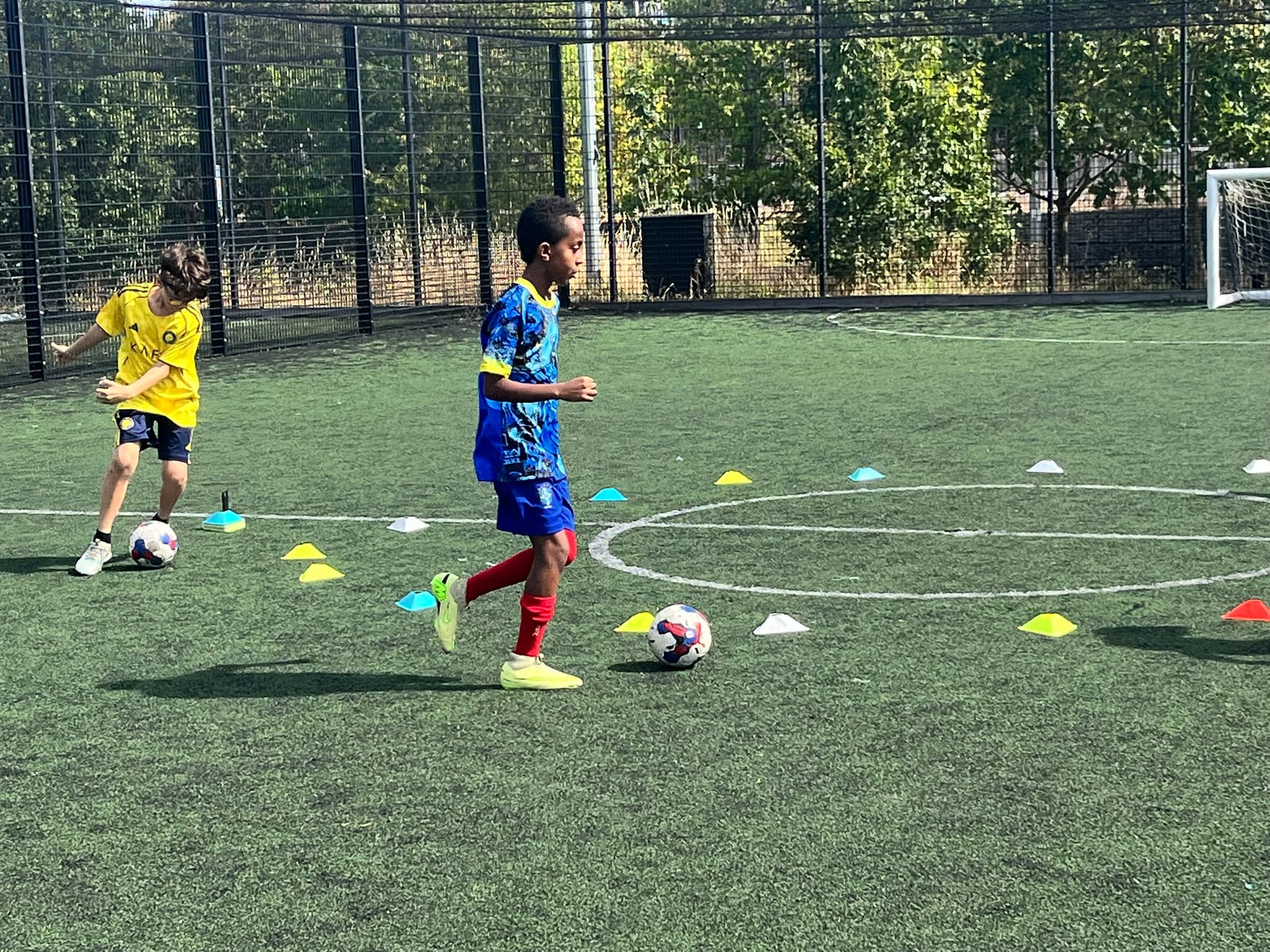 Young people of all backgrounds playing football together at Youth Active