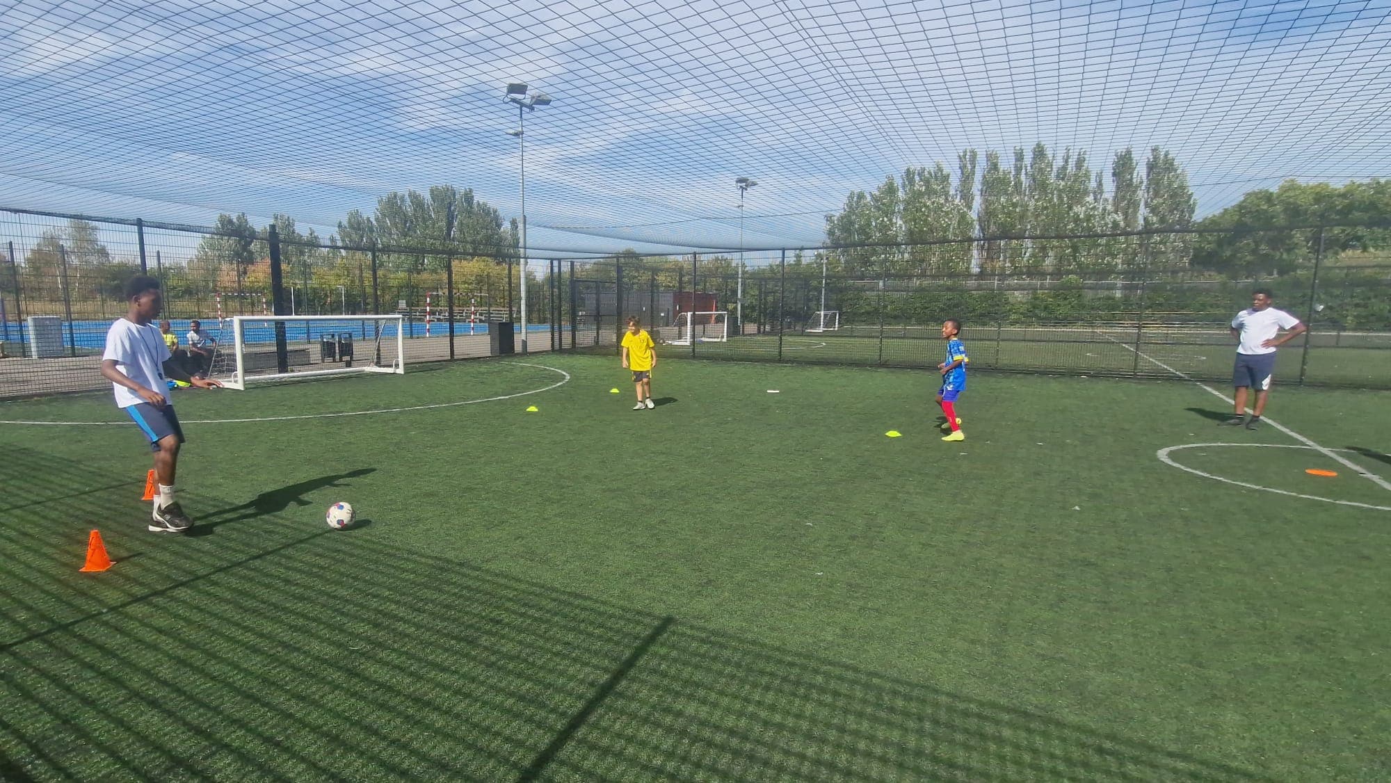 Young people practising ball control at an outdoor football session